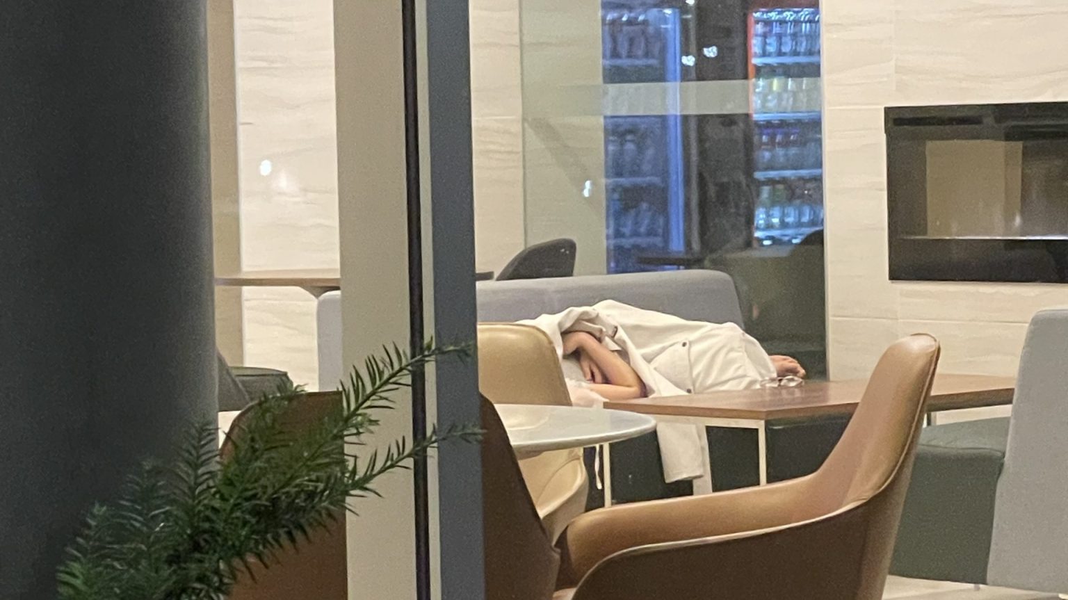 Person sleeping in lobby.